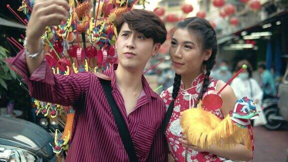 在泰国曼谷唐人街的街头市场购物的亚洲夫妇