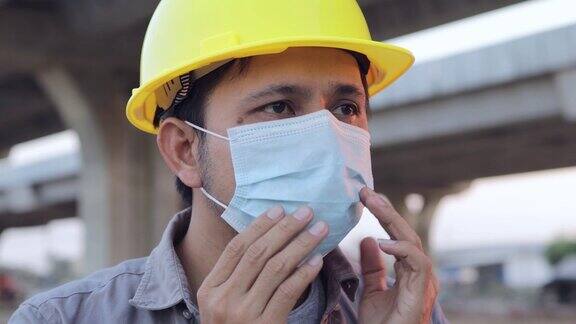 亚洲建筑工人戴着口罩