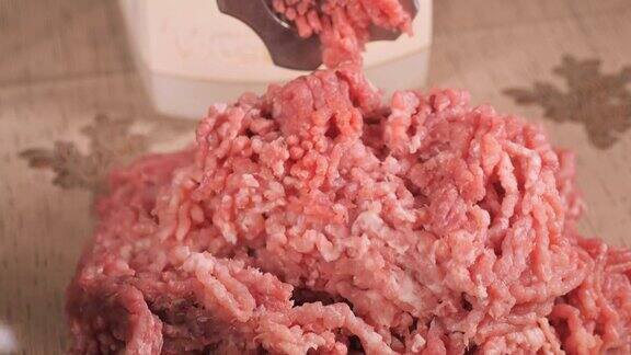 馅料通过绞肉机的筛子出来绞肉机关闭一堆碎肉绞肉机与新鲜切碎的肉在厨房用绞肉机磨肉的过程