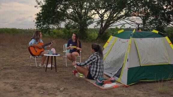 女人们在夏令营里唱歌、弹吉他