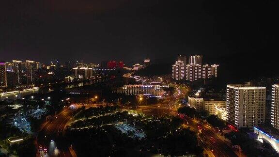 夜晚照亮三亚城市景观河边交通街道航拍全景4k中国海南