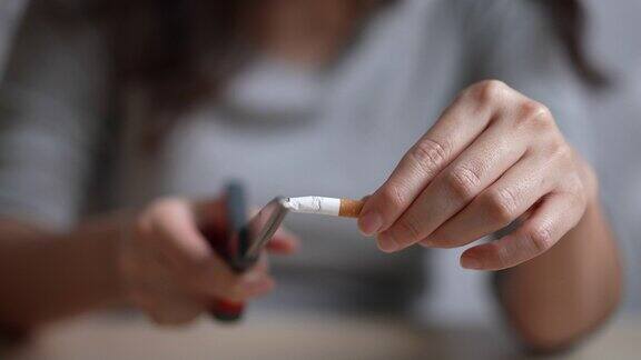 女人用剪刀剪香烟戒烟概念慢镜头