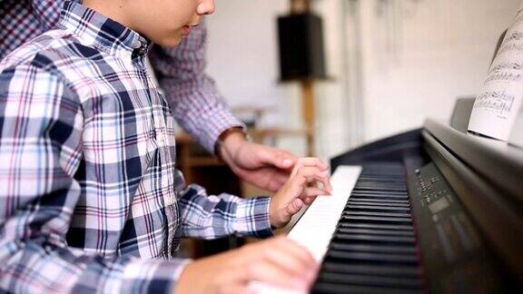 一位小男孩在上钢琴课