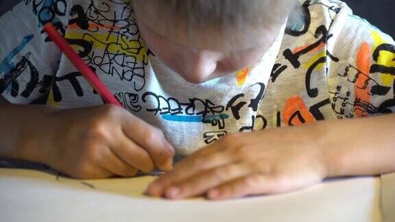 一个六岁的孩子用彩色铅笔画画