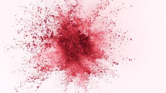 红色粉末在白色背景上以超慢镜头爆炸