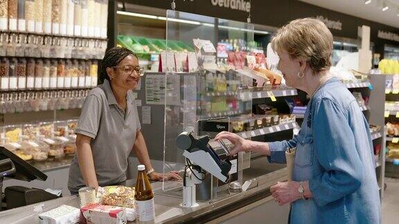 在超市买杂货的老年女性顾客