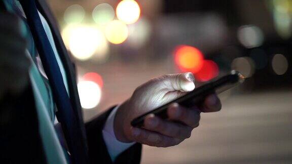 商人在晚上使用手机