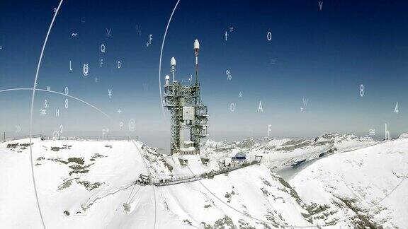 无线电天线在冰雪覆盖的山脉环境与计算机动画符号象征通信的航拍