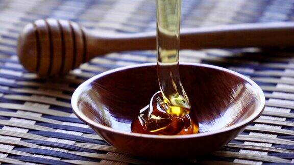 用慢动作将蜂蜜倒在木杯上