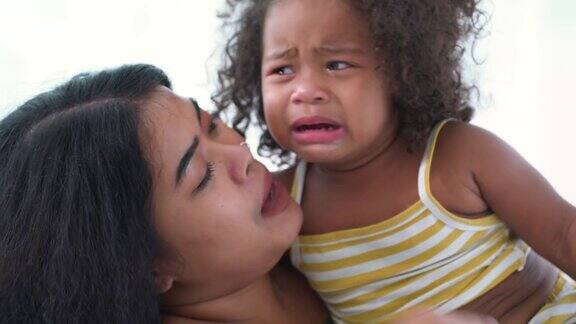母亲安慰正在哭泣的小女儿