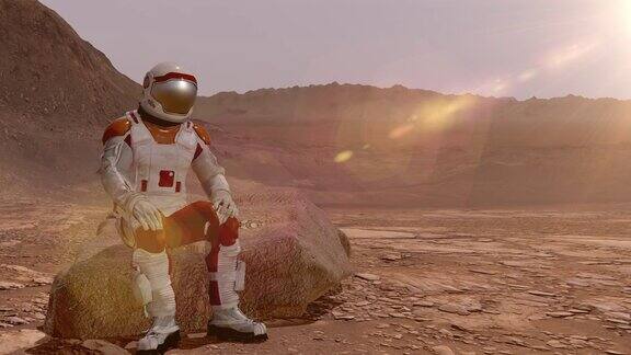 宇航员坐在火星上欣赏风景火星探索任务未来主义殖民和空间探索概念这段视频由美国宇航局提供三维渲染