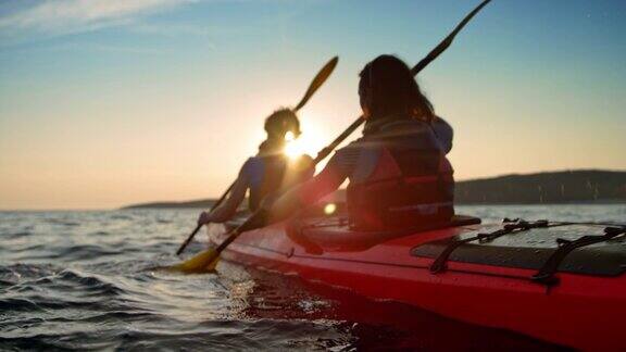 SLOMO夫妇在一个红海皮划艇经过的水在阳光下