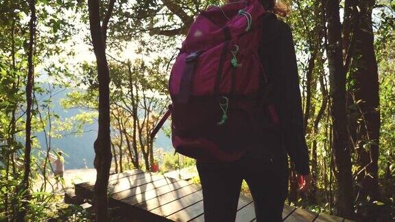 一个背包女在森林里徒步旅行的慢镜头