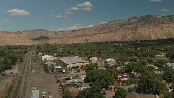 SummerAerialDroneViewPalisadeColoradoRiverBasinagriculturalGreenSpaceandWaterTreatmentandBookCliffMounta