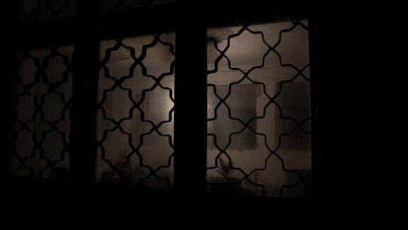 一扇紧闭的玻璃门上有一个不明人影的剪影夜晚一个人在窗前的剪影恐怖的场景万圣节概念模糊剪影的疯子