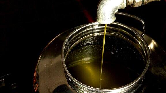 橄榄油生产:特级初榨橄榄油挤压后落入钢罐中