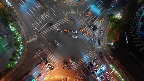 夜晚照亮三亚市交通街道十字路口高空俯视图4k中国海南