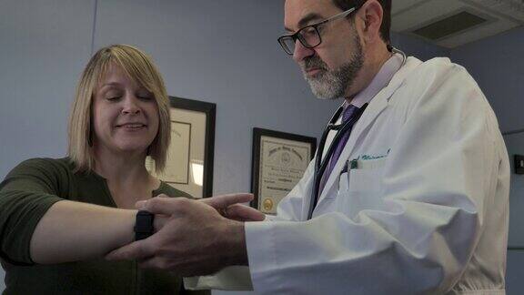 男医生教女病人如何使用智能手表健康应用