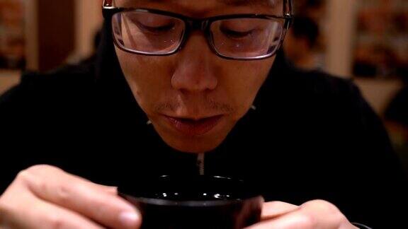 亚洲人在日本餐厅喝汤