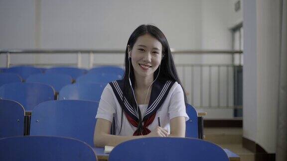 年轻的亚洲女大学生在教室里使用笔记本电脑