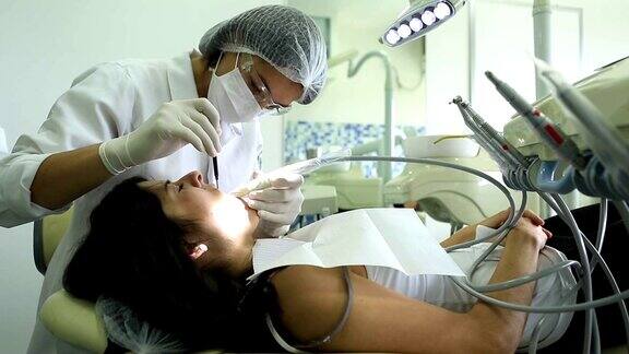 牙医正在检查病人的牙齿妇女工作的病人的牙痛和牙科保健卫生