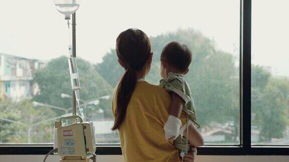 在医院里母亲安慰并拥抱她的儿子