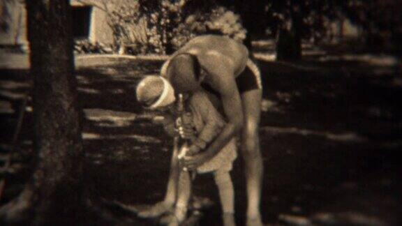 1937年:爸爸教女儿钩针运动用小木槌击球