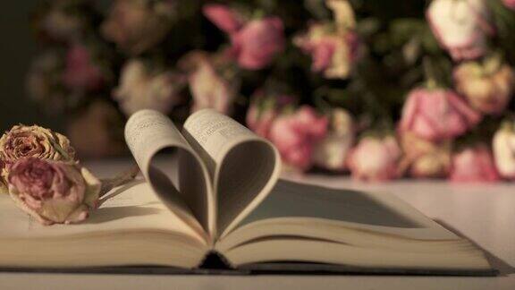 一束枯萎的玫瑰用心打开一本书