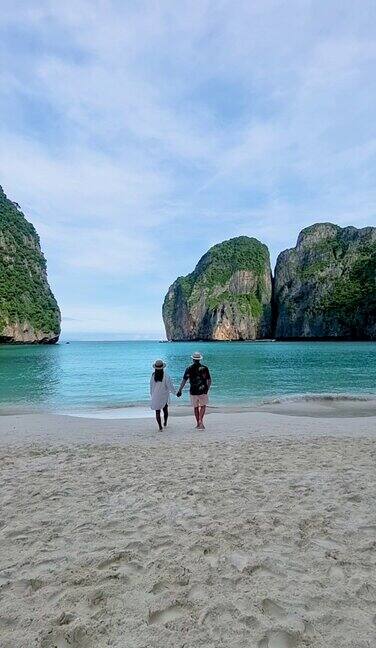一对男女走在海滩上泰国披披岛玛雅海滩的清晨