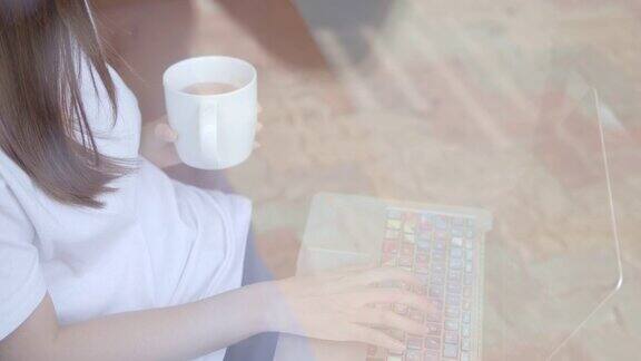 亚洲年轻人在喝咖啡休息时间用笔记本电脑