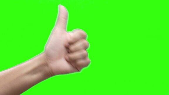 在绿色屏幕背景上竖起大拇指
