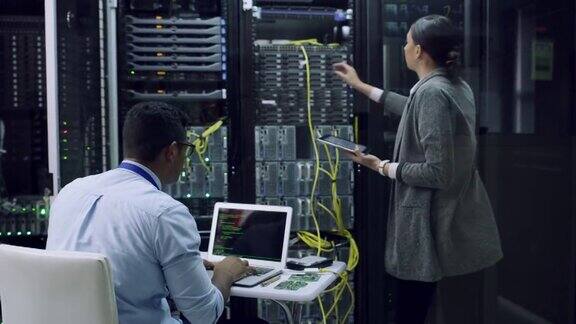 两名技术人员在服务器室一起工作的4k视频片段