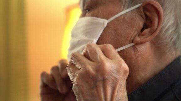 特写亚洲男子戴着口罩在家咳嗽