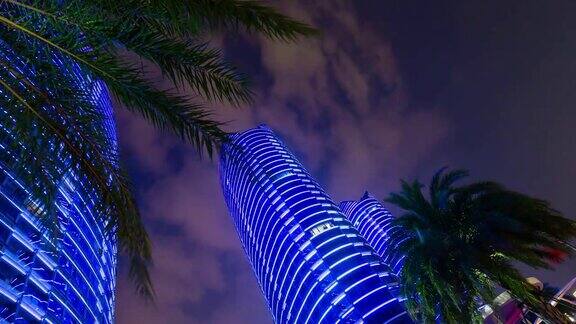 夜晚照亮三亚市著名的公寓大楼俯瞰4k时间的中国海南岛
