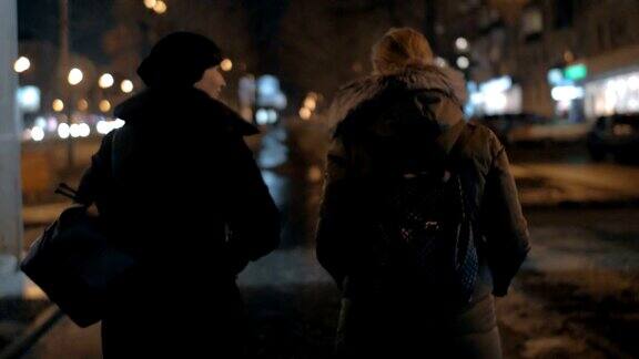 两个女人在冬夜城市散步时聊天