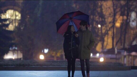 女朋友和男朋友一起走女孩撑着伞浪漫的约会
