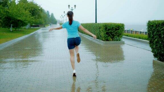 快乐的女人在雨中蹦蹦跳跳