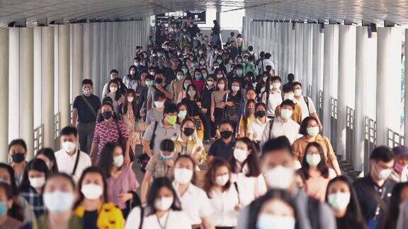 亚洲人在早高峰时间戴着防护面罩去曼谷上班以预防冠状病毒或新冠病毒以及空气中的微尘pm2.5