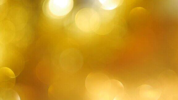 散焦明亮的金色闪烁灯创建柔和的散焦圈作为背景