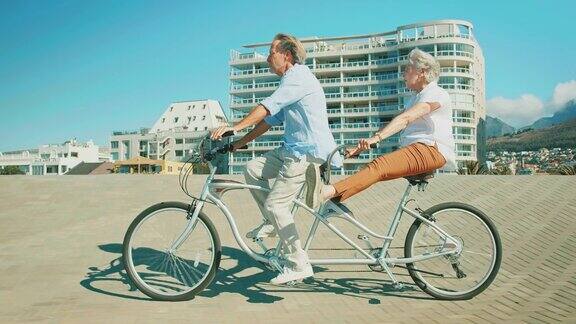 老年夫妇在夏天享受双人自行车