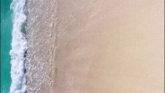 无人机俯拍海浪拍打在沙滩上
