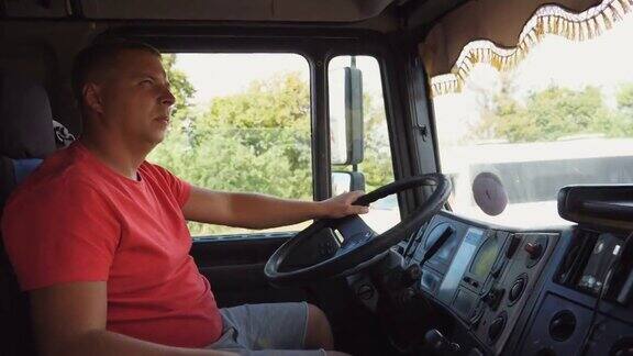 卡车司机手握方向盘控制卡车驶向目的地驾驶汽车穿越乡村的人在乡村公路上行驶的卡车司机物流运输理念