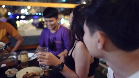 一群年轻的亚洲朋友在户外餐厅聚会喝酒