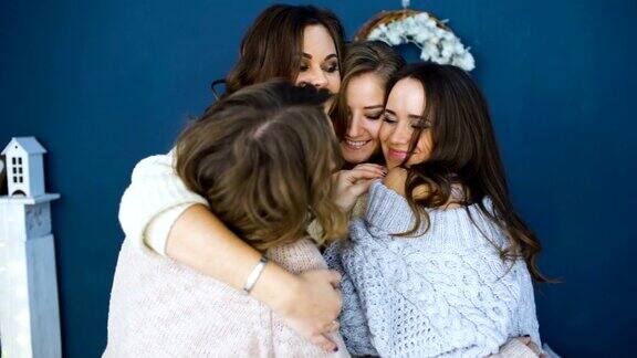 四个漂亮的女孩互相拥抱闺蜜们在卧室里开怀大笑