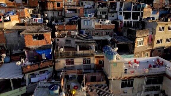 巴西里约热内卢的贫民窟:日出时从山上的房屋旁升起