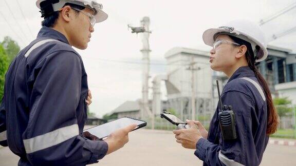 工程师控制无人机飞行检查电力烟囱发电生物质发电厂工厂