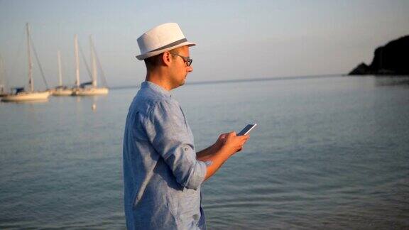 一个年轻人在海滩上发短信