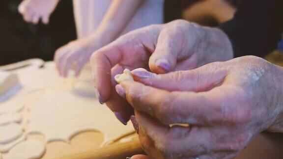 女人包饺子新年团圆节日妈妈和女儿的手制作饺子食物的特写