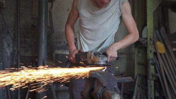 亚洲铁匠在他的铁匠铺里打磨