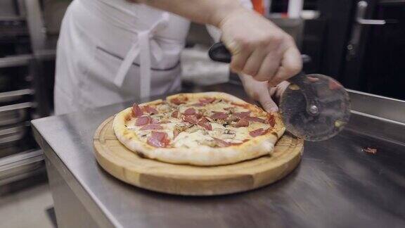 厨师用一把特制的刀切披萨香肠披萨蘑菇西红柿和奶酪